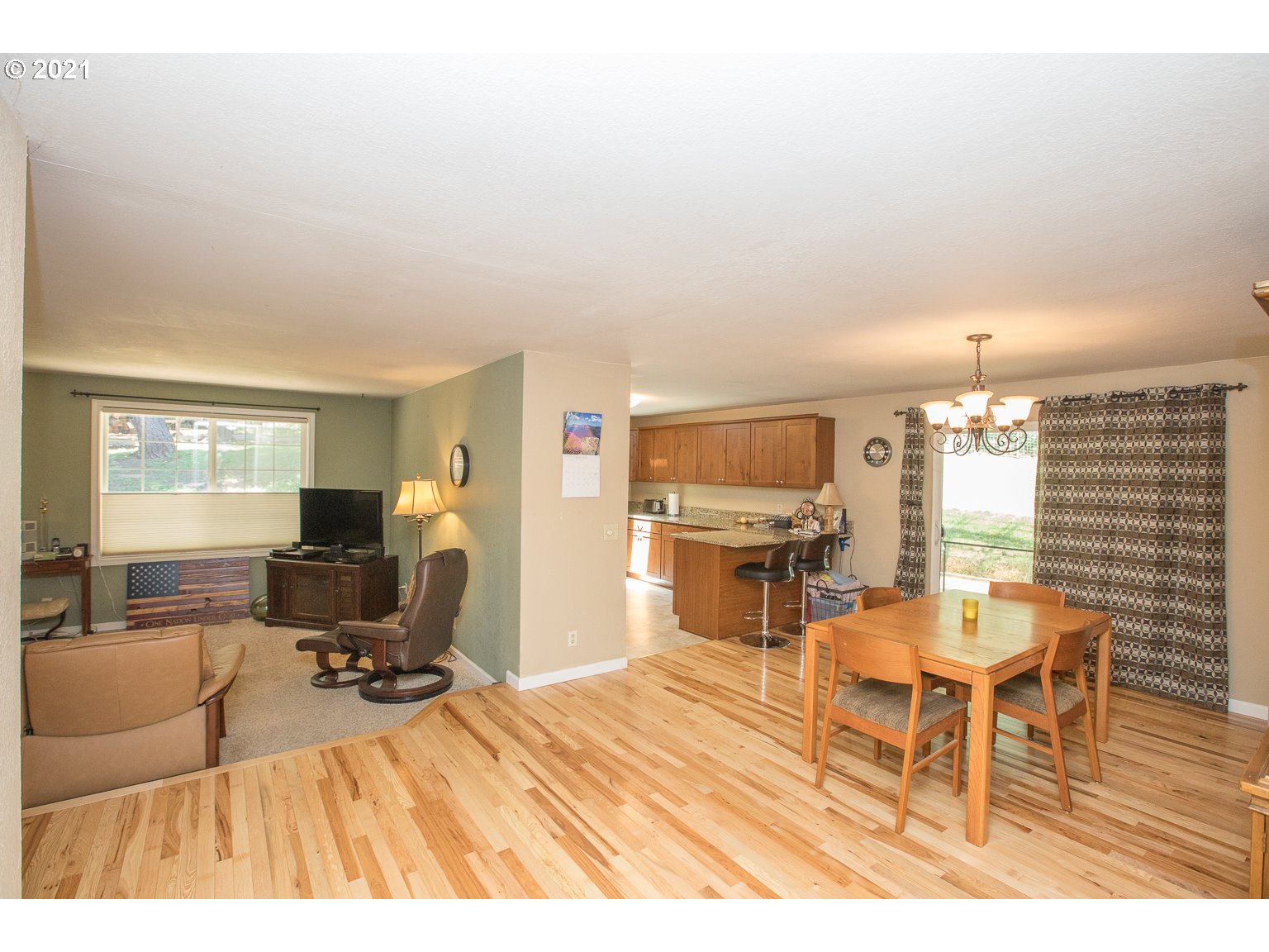 90361 Baker Road Elmira, OR 97437 - Photo 7 of 26 a living room with furniture a dining table and chairs with kitchen view