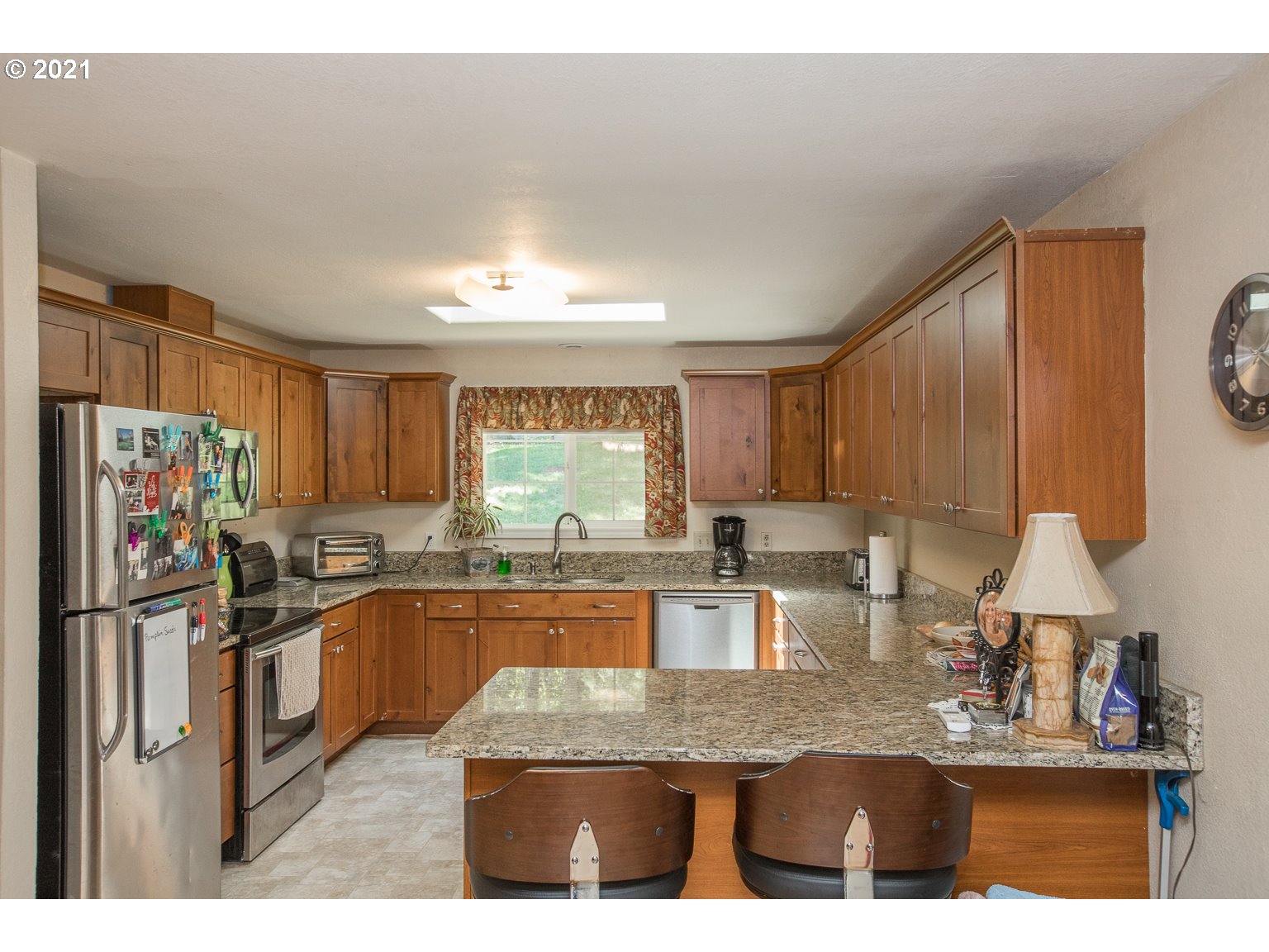 90361 Baker Road Elmira, OR 97437 - Photo 9 of 26 a kitchen with stainless steel appliances granite countertop a sink refrigerator stove and microwave