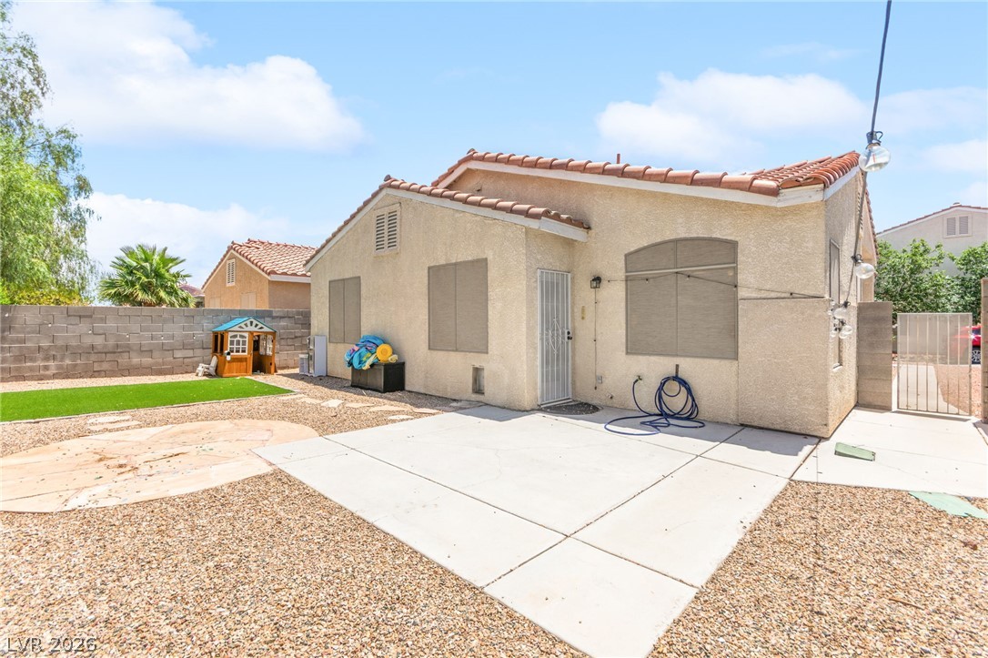 7353 Ridge Star Court Las Vegas, NV 89131 - Photo 4 of 36 A spacious backyard features a paved patio area and decorative gravel, perfect for outdoor activities.