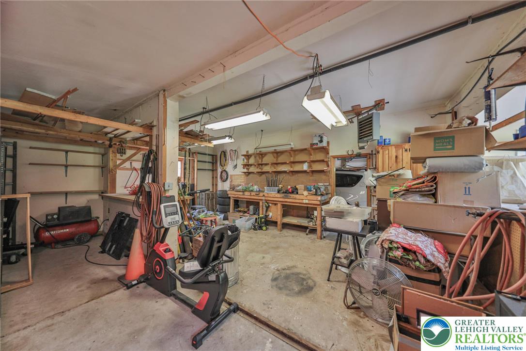 331 Cranberry Creek Road Cresco, PA 18326 - Photo 37 of 95 A versatile garage space ready for projects or storage, featuring sturdy built-in shelving and ample room.