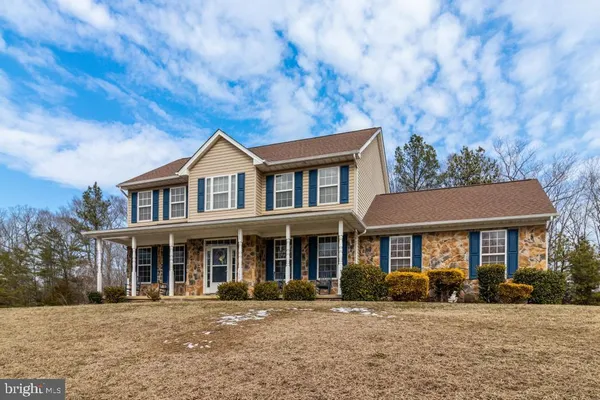 a front view of a house with yard porch and outdoor seating