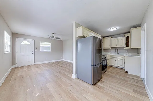 a kitchen with granite countertop a refrigerator and a stove top oven