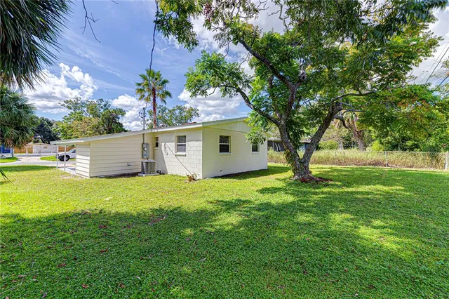 a view of a backyard with large trees