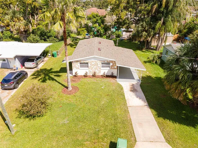 a aerial view of a house with a yard