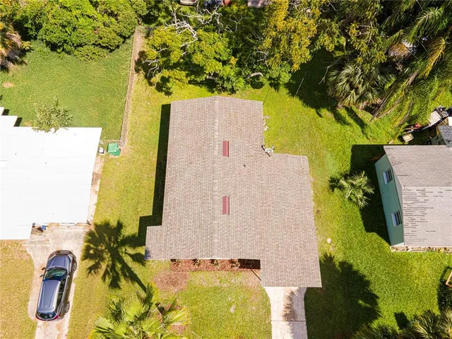 an aerial view of residential house with pool and garden
