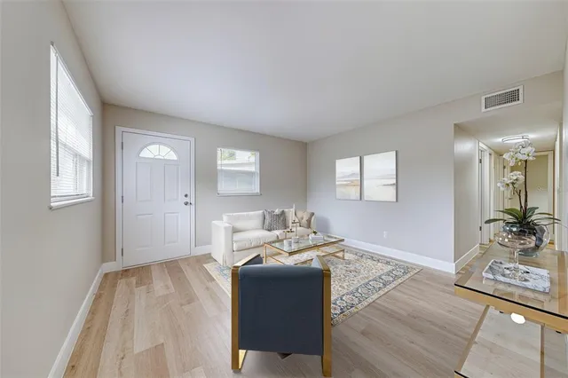 a living room with furniture and a potted plant