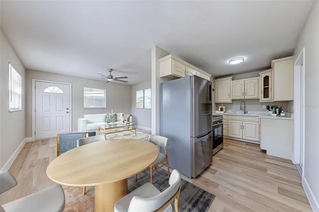 a kitchen with refrigerator and white cabinets