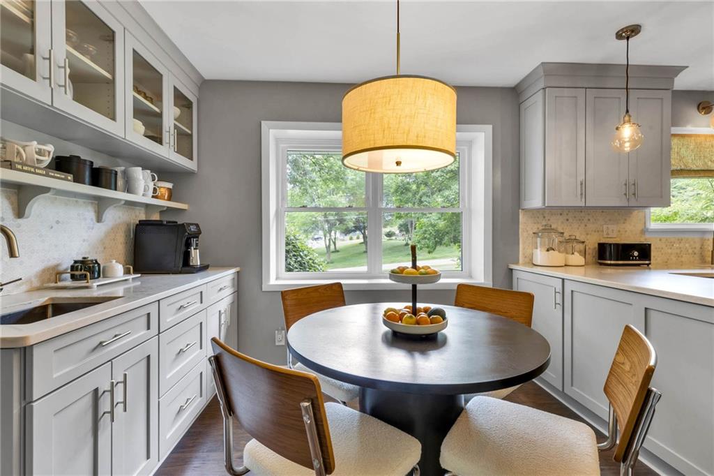139 Laurel Drive Beaver, PA 15009 - Photo 13 of 46 a kitchen with stainless steel appliances a dining table chairs and a wooden floor