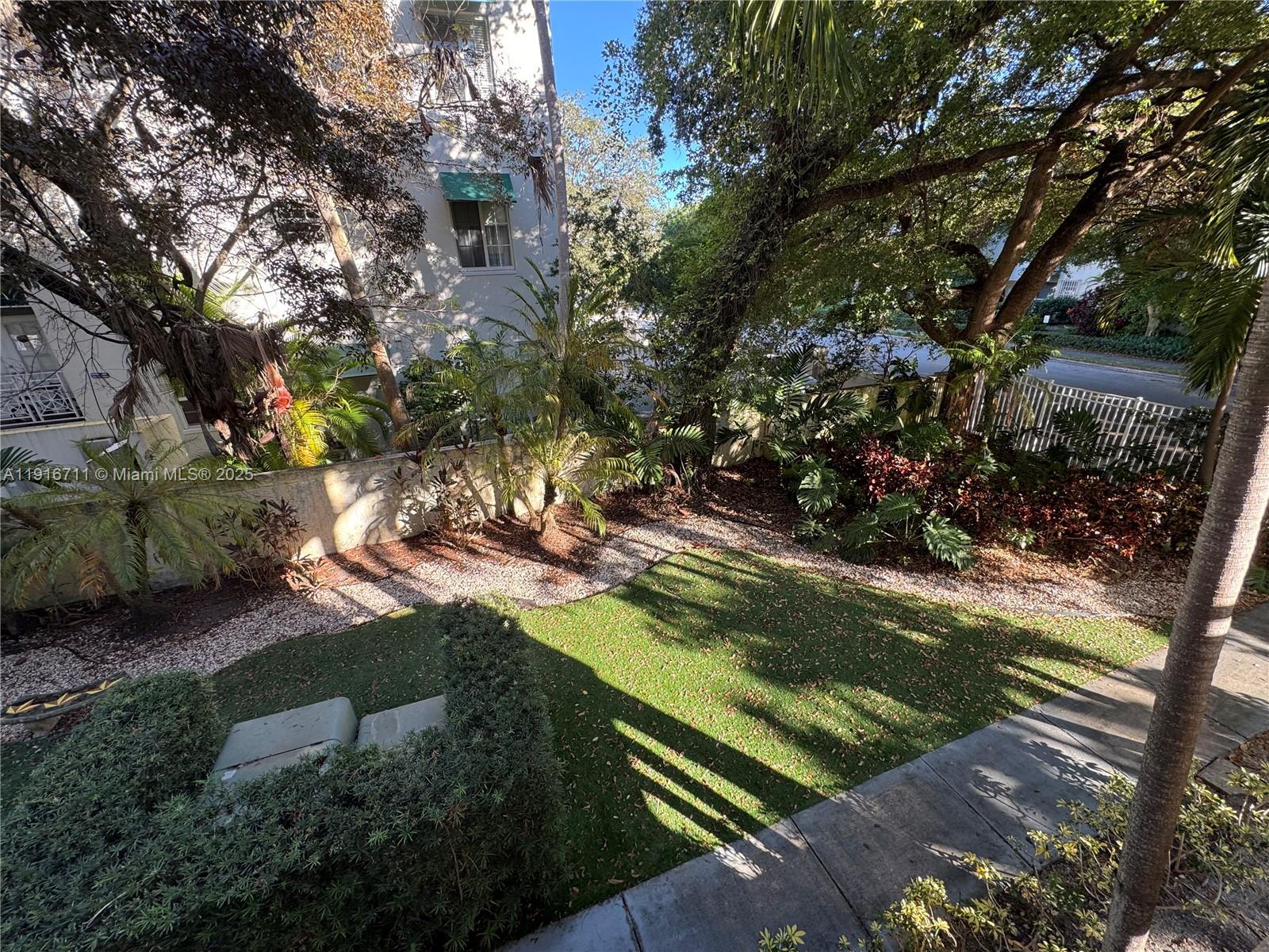 5839 Southwest 74th Terrace, Unit 104 South Miami, FL 33143 - Photo 16 of 25 a view of a yard with wooden fence