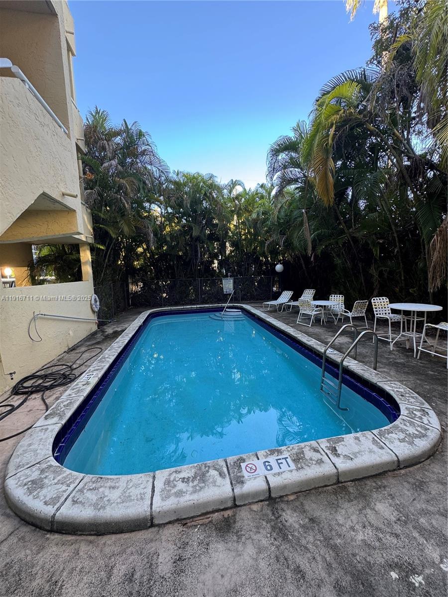 5839 Southwest 74th Terrace, Unit 104 South Miami, FL 33143 - Photo 20 of 25 a view of outdoor space and swimming pool