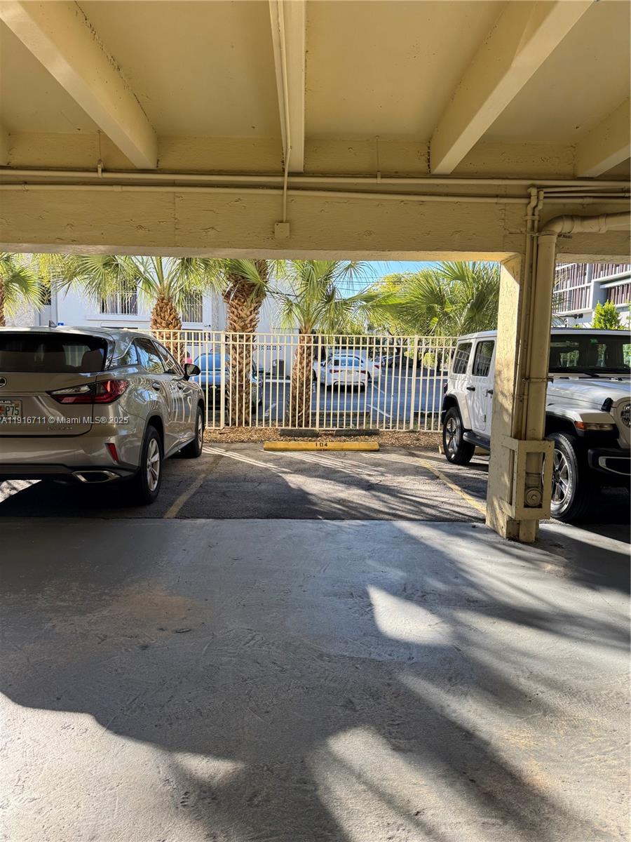 5839 Southwest 74th Terrace, Unit 104 South Miami, FL 33143 - Photo 21 of 25 a view of car parked on the road