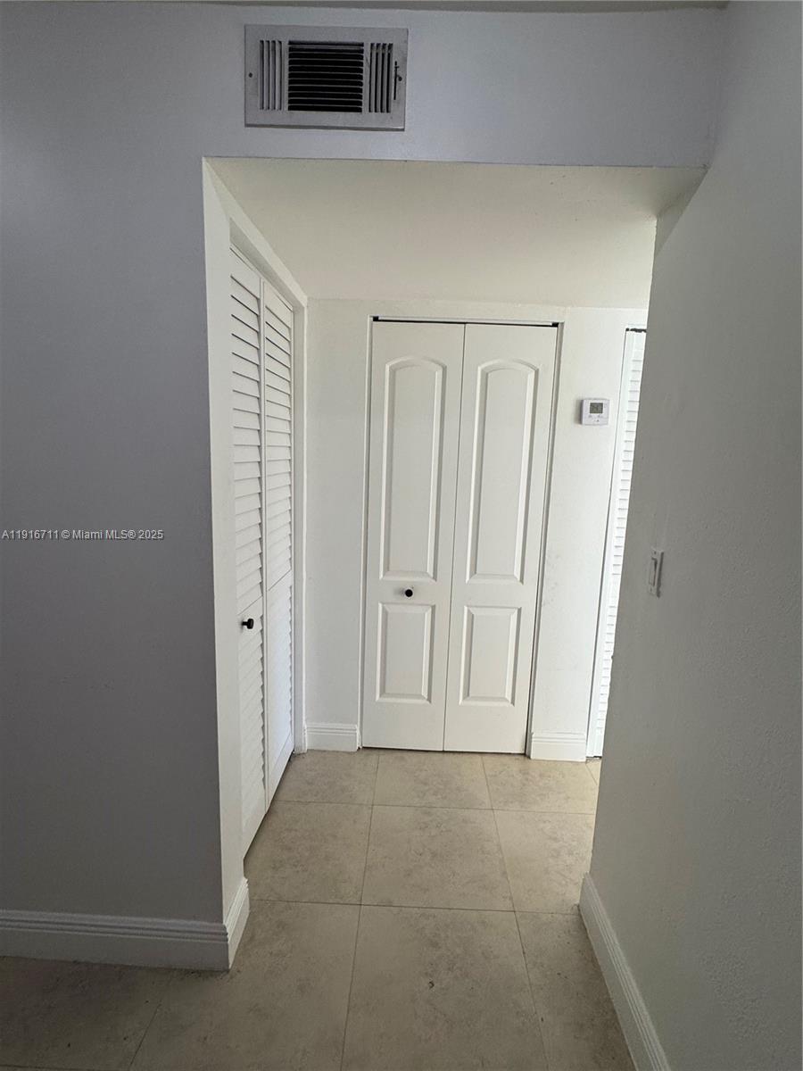 5839 Southwest 74th Terrace, Unit 104 South Miami, FL 33143 - Photo 7 of 25 a view of an entryway with hallway