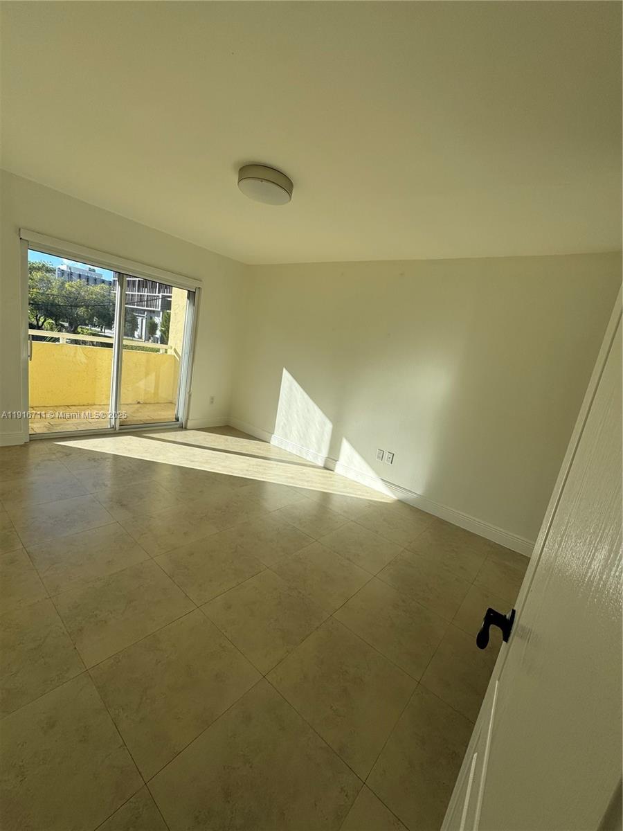 5839 Southwest 74th Terrace, Unit 104 South Miami, FL 33143 - Photo 10 of 25 a view of an empty room with a window