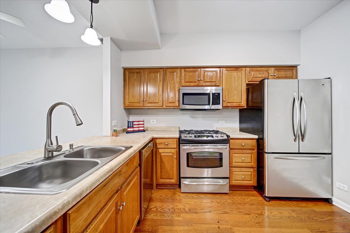 351 Fallbrook Court Schaumburg, IL 60107 - Photo 24 of 29 a kitchen with stainless steel appliances granite countertop a sink stove and refrigerator