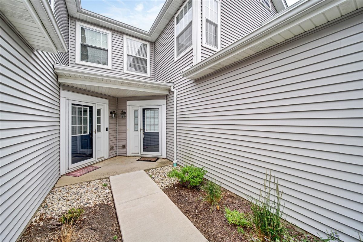 351 Fallbrook Court Schaumburg, IL 60107 - Photo 5 of 29 a view of a house with large windows and flower plants