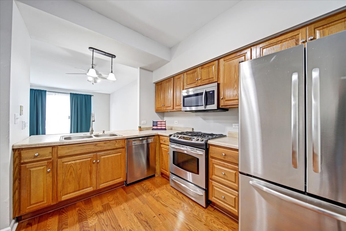 351 Fallbrook Court Schaumburg, IL 60107 - Photo 7 of 29 a kitchen with stainless steel appliances granite countertop a refrigerator a stove top oven a sink and dishwasher