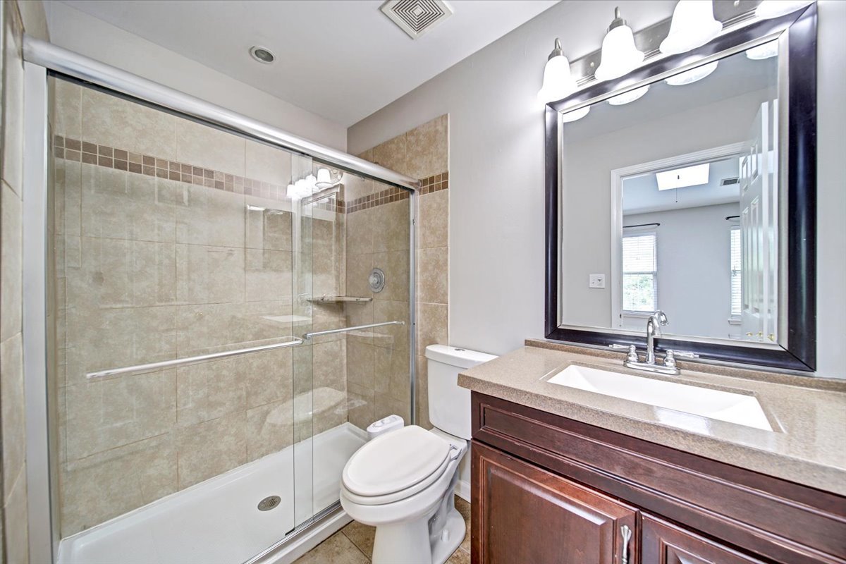 351 Fallbrook Court Schaumburg, IL 60107 - Photo 8 of 29 a bathroom with a sink a toilet a mirror and shower