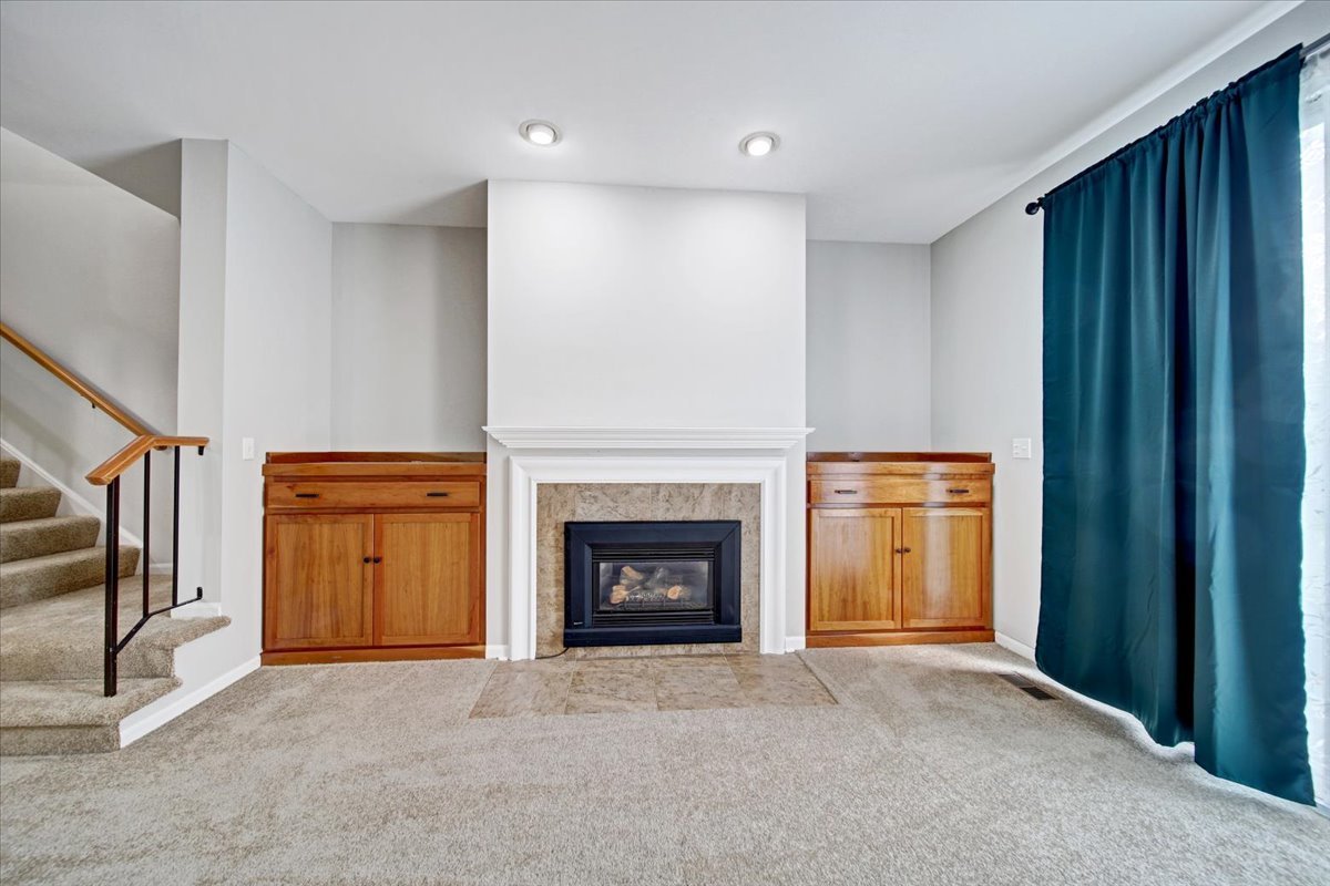 351 Fallbrook Court Schaumburg, IL 60107 - Photo 9 of 29 a view of an empty room with fire place and a fireplace
