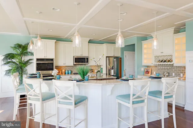 a kitchen with stainless steel appliances kitchen island granite countertop a sink and cabinets