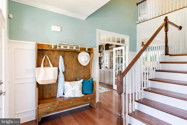 a view of entryway and hall with wooden floor