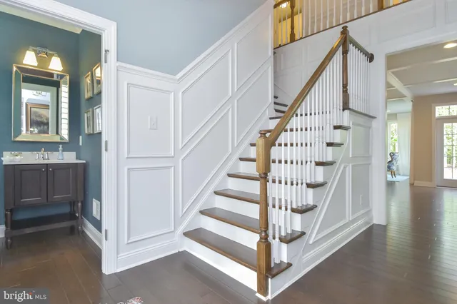 a view of a hallway with wooden floor and entryway