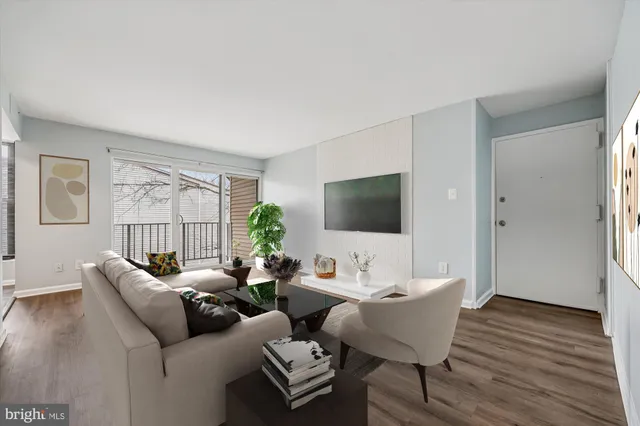 a living room with furniture a flat screen tv and a large window