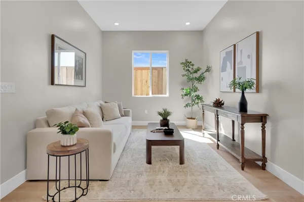 a living room with furniture potted plant and window