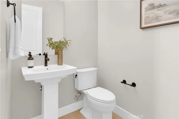 a bathroom with a sink a toilet and mirror