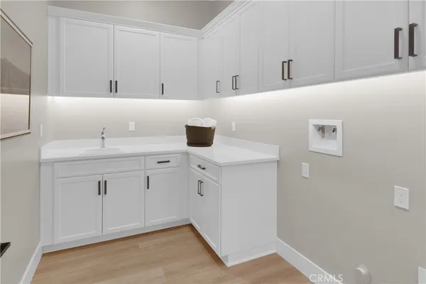 a view of a kitchen with white cabinets