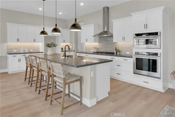 a kitchen with appliances a sink and cabinets