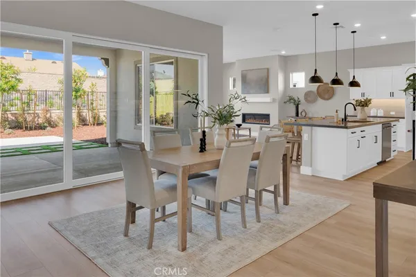 a dining room with furniture a floor to ceiling window and chairs