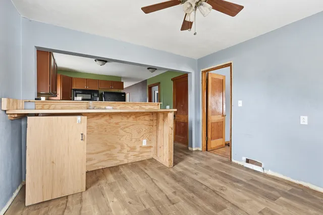 a view of a kitchen with a sink and a refrigerator