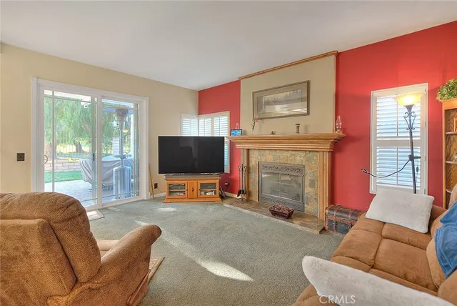 a living room with furniture a rug and a window