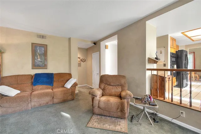 a dining hall with stainless steel appliances granite countertop a sink a stove a refrigerator with a dining table and chairs