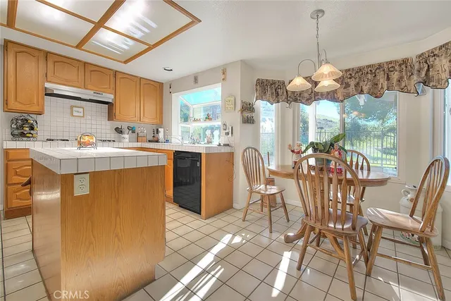 a dining room with furniture a chandelier and window
