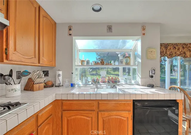 a kitchen with a sink a stove and a refrigerator