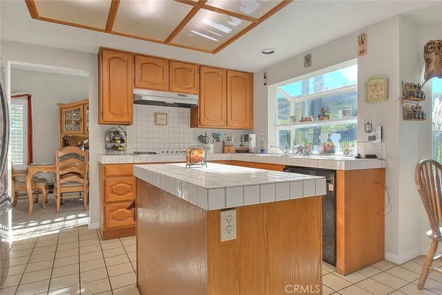 a large kitchen with granite countertop a sink and cabinets