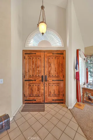 a living room with furniture a dining table and a chandelier