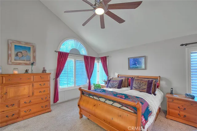 a living room with a bed furniture and a potted plant