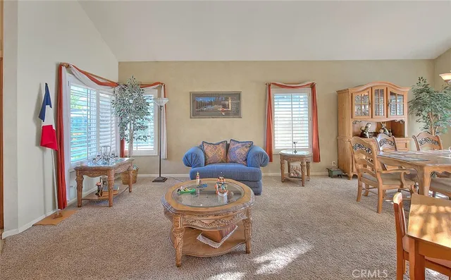 a view of a dining room with furniture wooden floor and a chandelier