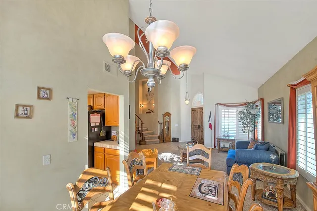 a living room with furniture a fireplace and a chandelier