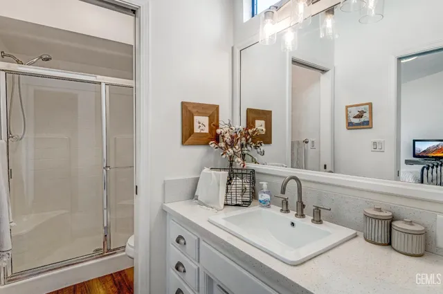 a bathroom with a double vanity sink mirror and toilet