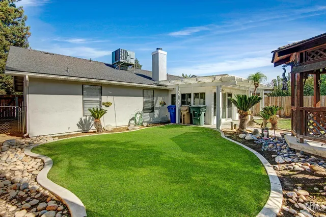 a front view of a house with a yard porch and outdoor seating