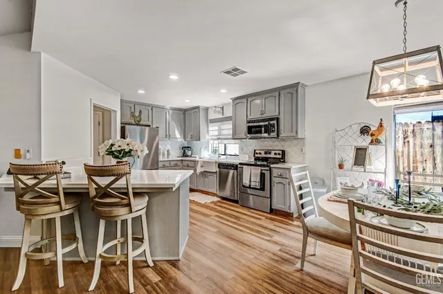 a view of a dining room with furniture kitchen and wooden floor