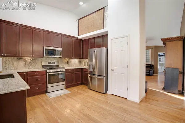 a kitchen with a refrigerator stove and sink