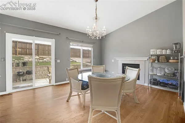 a view of a dining room with furniture wooden floor and a chandelier