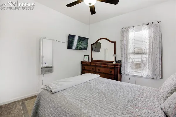 a bedroom with a bed and a television