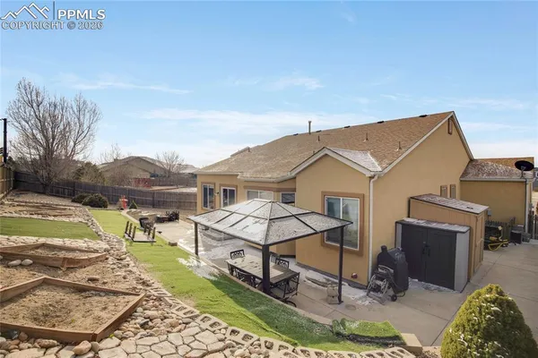 a view of a patio with table and chairs a barbeque