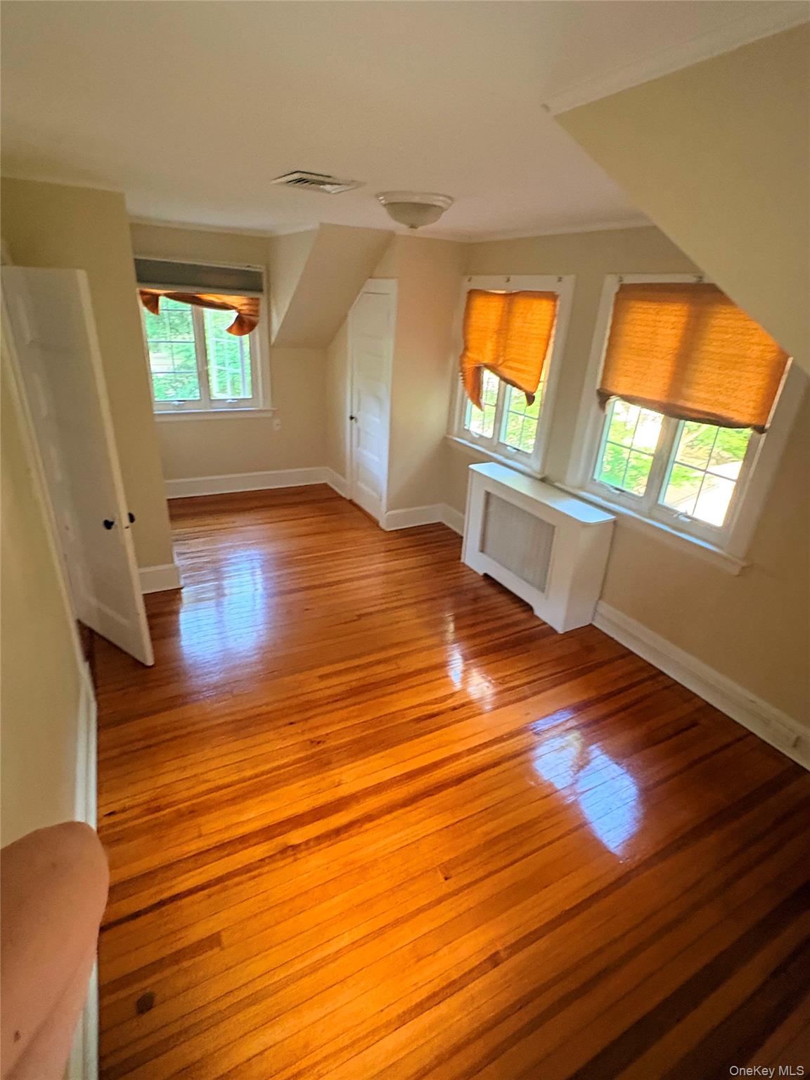 6 Tower Road Glen Cove, NY 11542 - Photo 9 of 12 a view of empty room with wooden floor and fan