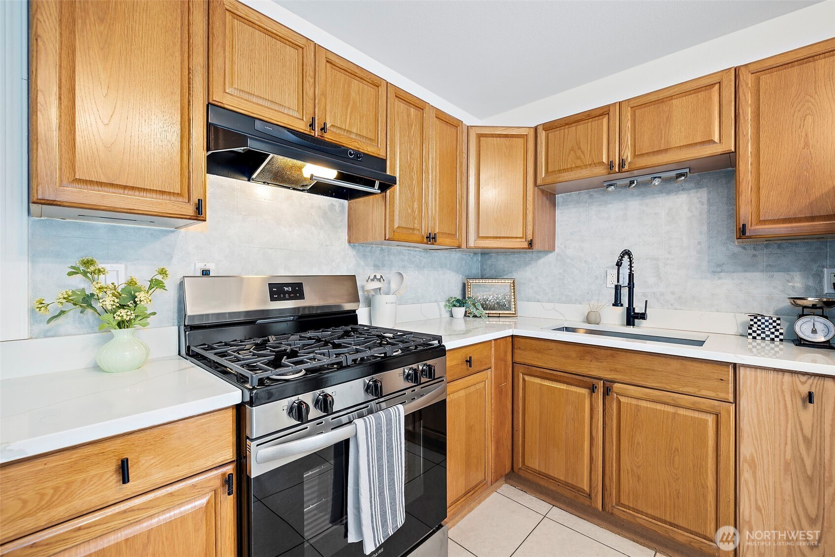 19250 Southeast 268th Street Covington, WA 98042 - Photo 13 of 37 a kitchen with stainless steel appliances granite countertop a sink a stove and cabinets